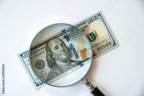 100 US Dollar under magnifying glass