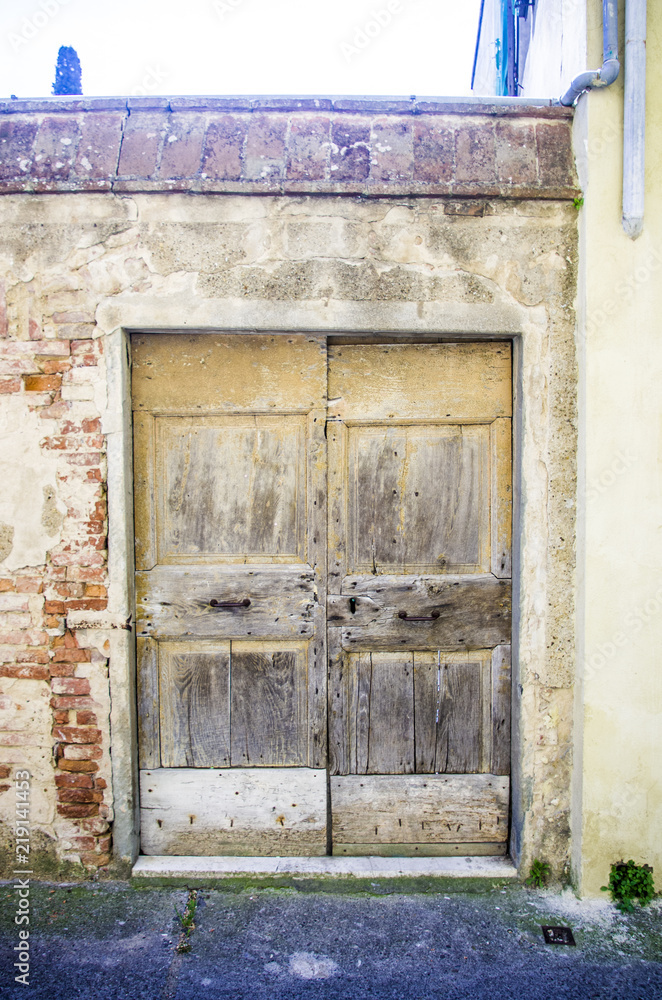 gate with wooden door of ancient urban villa