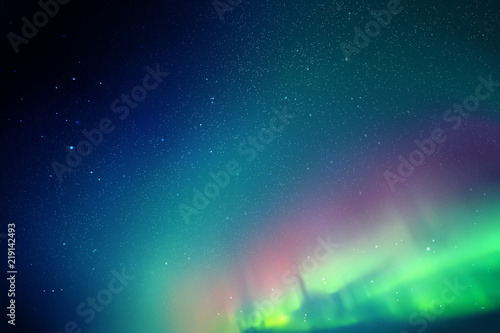 Night starry sky. Northern lights. Blue green aurora borealis