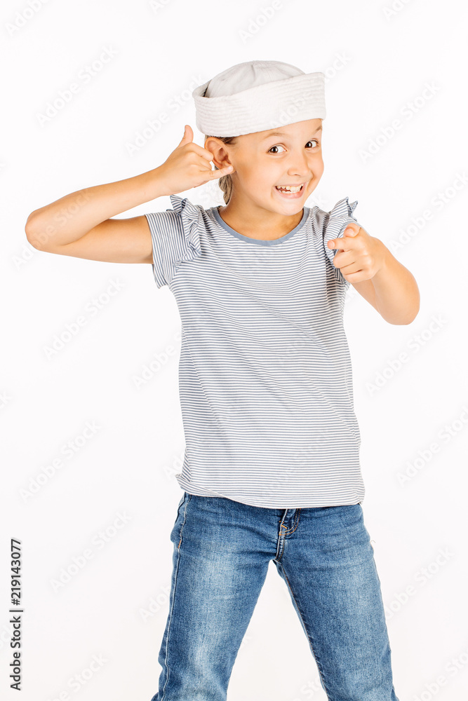 Little girl wearing a sailor costume and looking at the camera on white background. Little girl wearing a sailor costume and looking at the camera on white background.