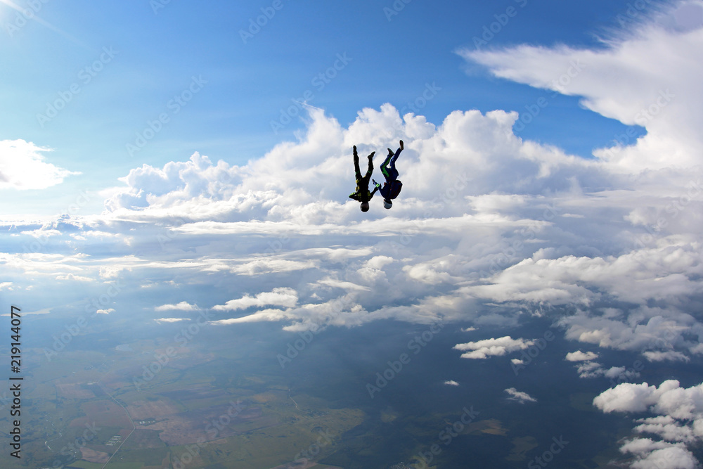 Two skydivers are falling in the amazing sky. Two skydivers are falling in the amazing sky.