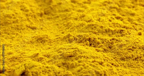 curcuma turmeric ground full frame on flat background, fly over elevated front view