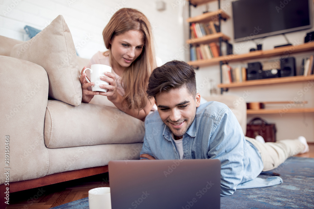 Beautiful young couple using laptop Beautiful young couple using laptop