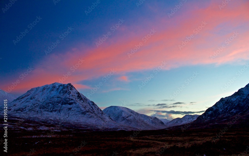 Beautiful Sunset over Snowy Mountains in Scotland, UK
