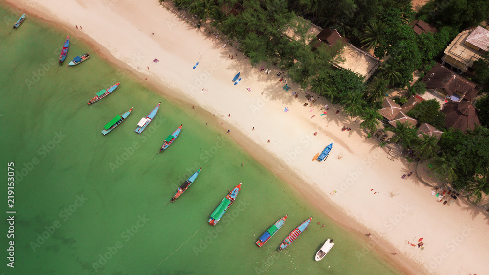 Aerial: Thai long tail taxi boats parking along  Bottle beach,sand beach at koh Phangan island, Thailand