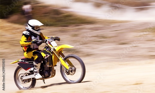 Rider on bike while Motocross race with motion blur background