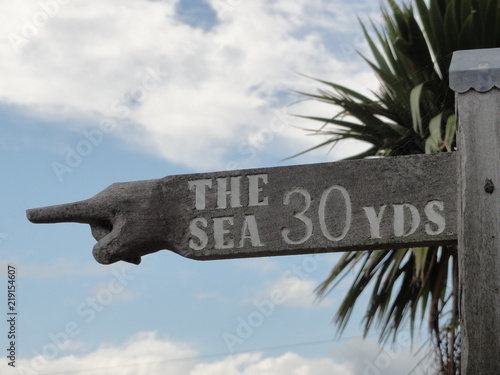 Wooden sign pointing to the sea