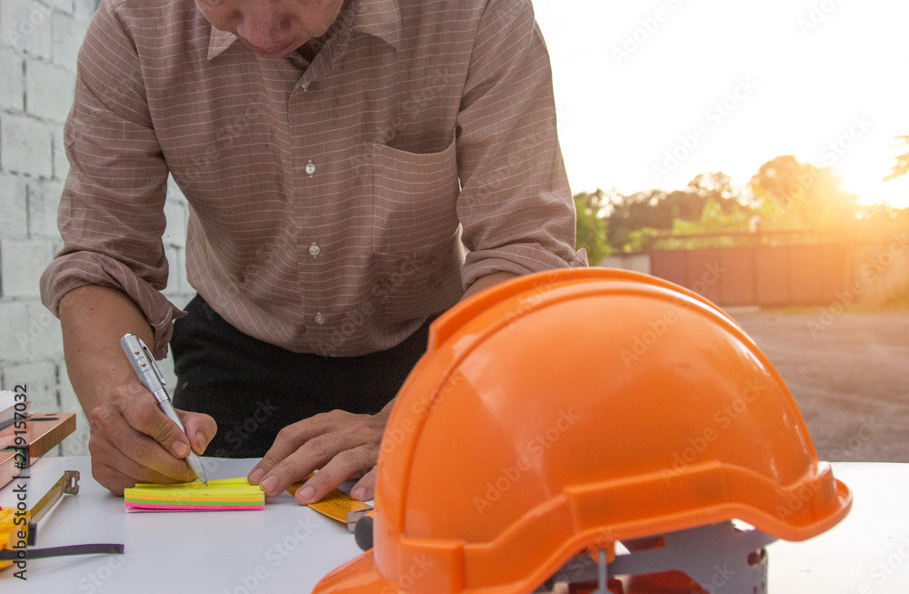Engineer and Architect planing and discuss at Construction Site with blueprint Engineer and Architect planing and discuss at Construction Site with blueprint