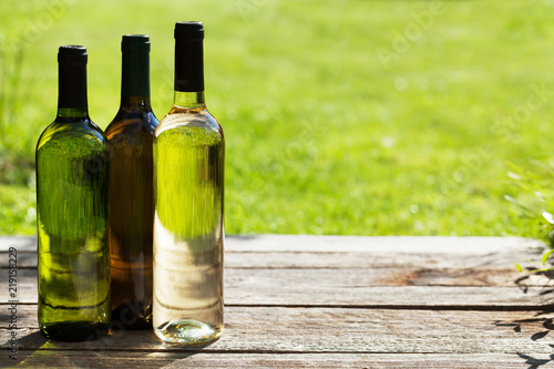White wine bottles on wooden table