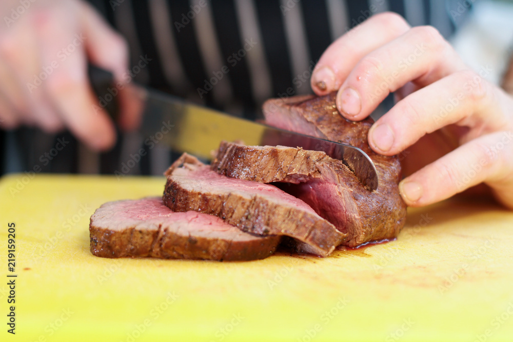 chef slicing fillet steak