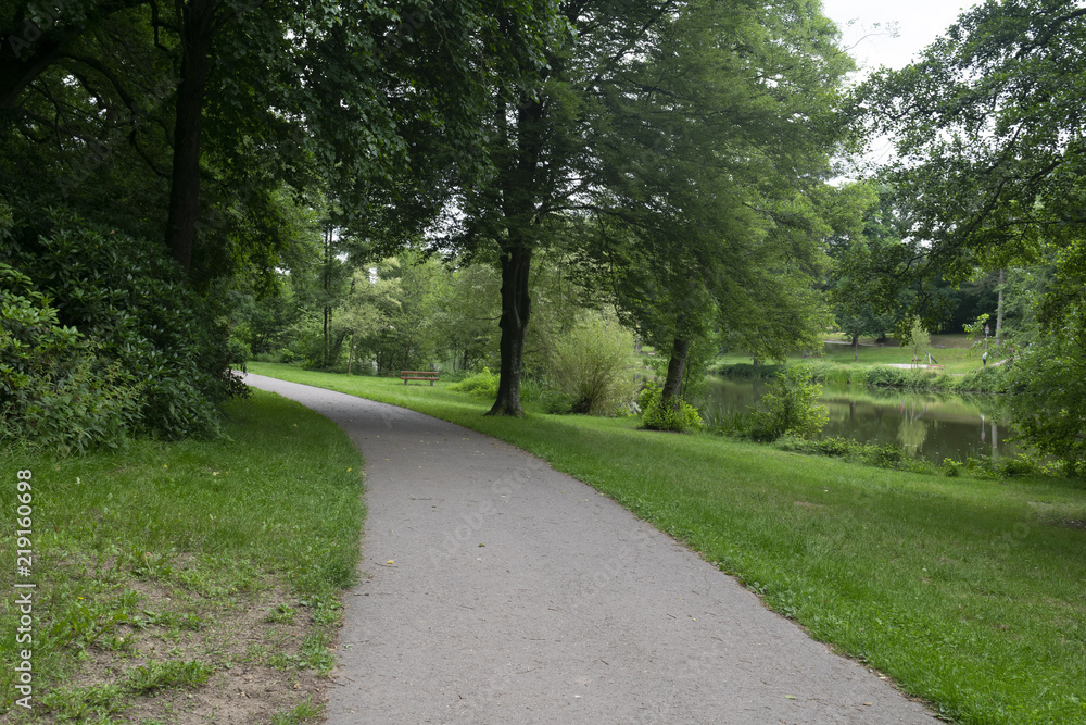 The path in Furpach city park. People go for walks or to rest in this small park. The path in Furpach city park. People go for walks or to rest in this small park.