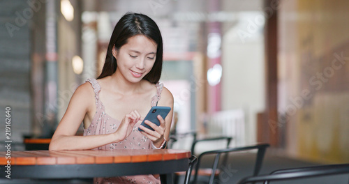 Woman use of smart phone in outdoor cafe photo