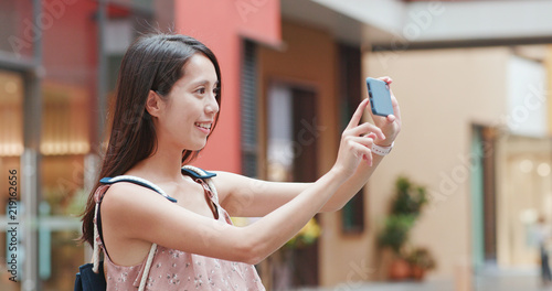 Woman taking photo on cellphone in Shum Yip upperhills photo