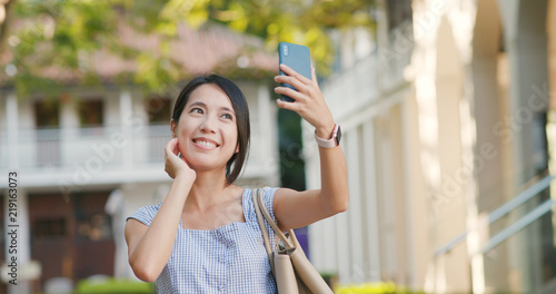 Woman take selfie on cellphone at outdoor