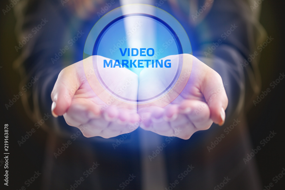 The concept of business, technology, the Internet and the network. A young entrepreneur working on a virtual screen of the future and sees the inscription: Video marketing The concept of business, technology, the Internet and the network. A young entrepreneur working on a virtual screen of the future and sees the inscription: Video marketing