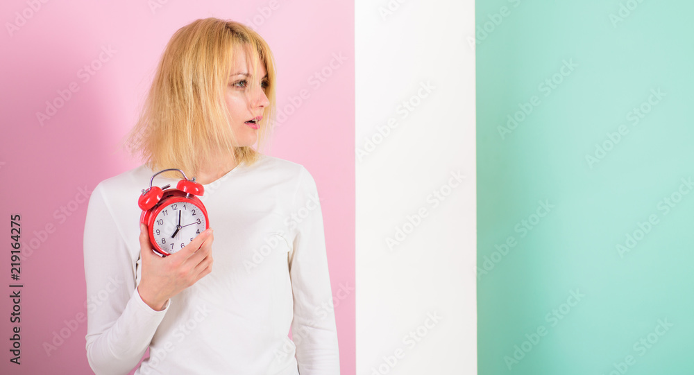 What time is it. Lack of sleep bad for health. Oversleeping side effects too much sleep harmful. Girl drowsy tousled hair just woke up holds alarm clock. Bad sleep habits effects on life, copy space What time is it. Lack of sleep bad for health. Oversleeping side effects too much sleep harmful. Girl drowsy tousled hair just woke up holds alarm clock. Bad sleep habits effects on life, copy space