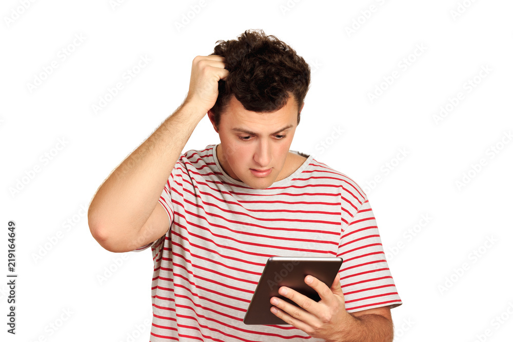 Young shocked student working on a digital tablet. emotional guy isolated on white background Young shocked student working on a digital tablet. emotional guy isolated on white background