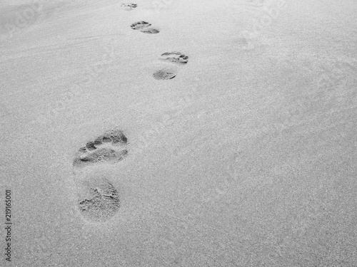 close up footprint on sand at the beach background in black and white color
