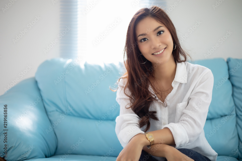 Asian women smiling happy for relaxation on sofa at home Asian women smiling happy for relaxation on sofa at home