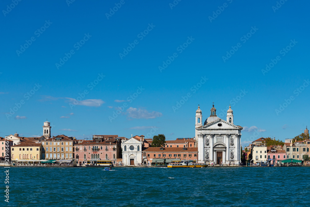Horizontal view of Chiesa di Santa Maria del veni Rosario and Venizia architectures along riverside on Venize  island, Italy  