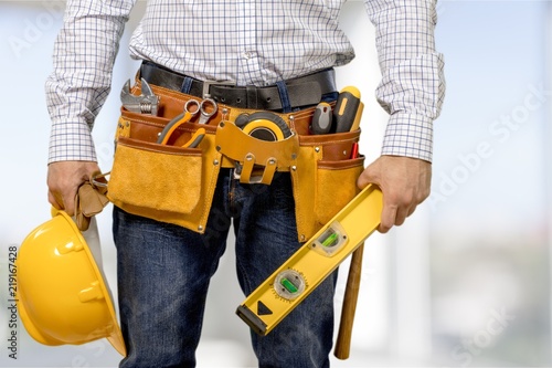Worker with a tool belt. Isolated over background.
