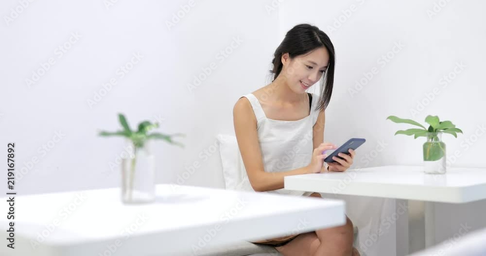 Woman use of mobile phone in restaurant
