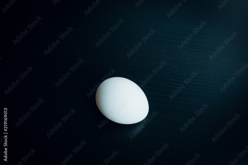 Chicken egg on dark table Chicken egg on dark table