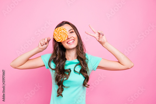 Careless beautiful young woman with toothy smile holds orange an