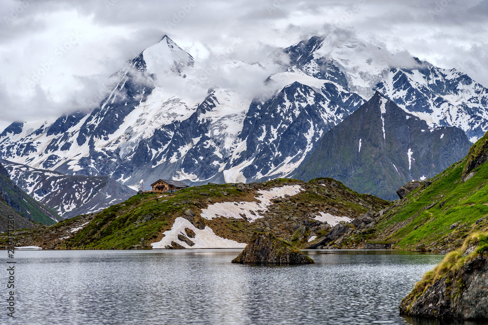 Obraz premium Swiss Alps water reflection in Lac de Louvie - mountain lake above Val de Bagnes valley, Switzerland.