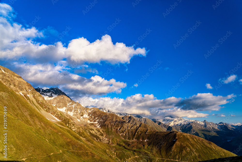 Obraz premium Dramatic sunset over mountains in Switzerland. Majestic mountains in warm golden light during sunset in Swiss Alps.
