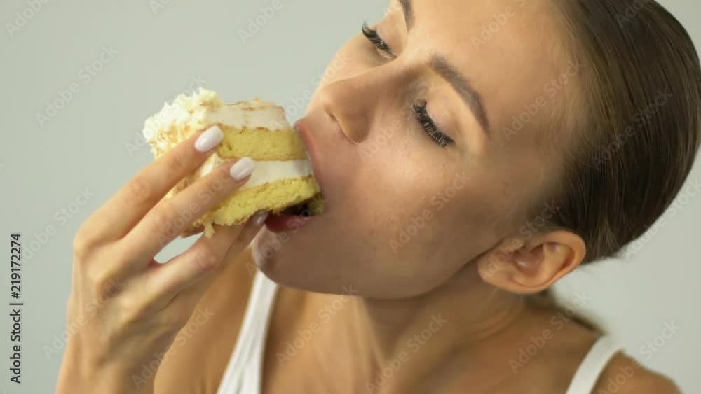 Girl on diet eating cake eagerly, temptation, sweets cause acne, skincare Girl on diet eating cake eagerly, temptation, sweets cause acne, skincare
