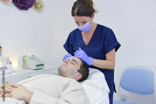 Young man on face treatment