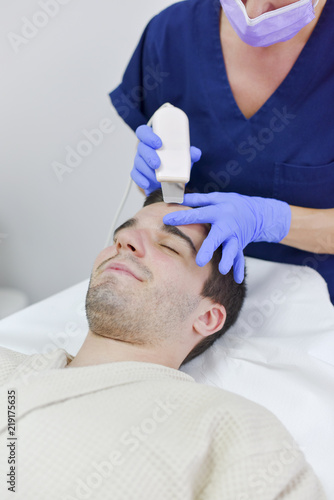Young man on face treatment