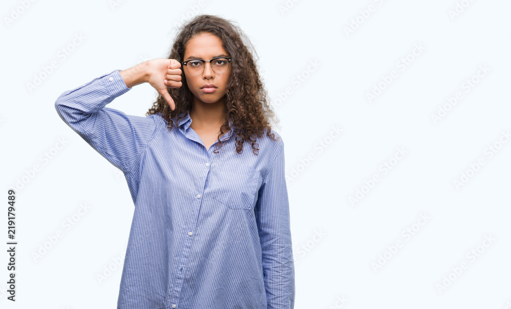 Beautiful young hispanic woman wearing glasses with angry face, negative sign showing dislike with thumbs down, rejection concept Beautiful young hispanic woman wearing glasses with angry face, negative sign showing dislike with thumbs down, rejection concept