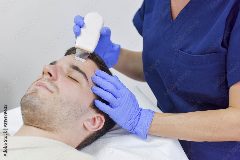 Young man on face treatment Young man on face treatment