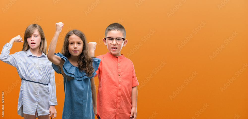 Group of boy and girls kids over orange background annoyed and frustrated shouting with anger, crazy and yelling with raised hand, anger concept Group of boy and girls kids over orange background annoyed and frustrated shouting with anger, crazy and yelling with raised hand, anger concept