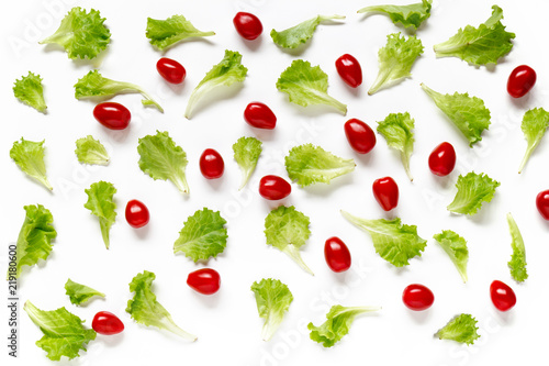 Vegetable background and texture  green salad leaf and red cherry tomatoes