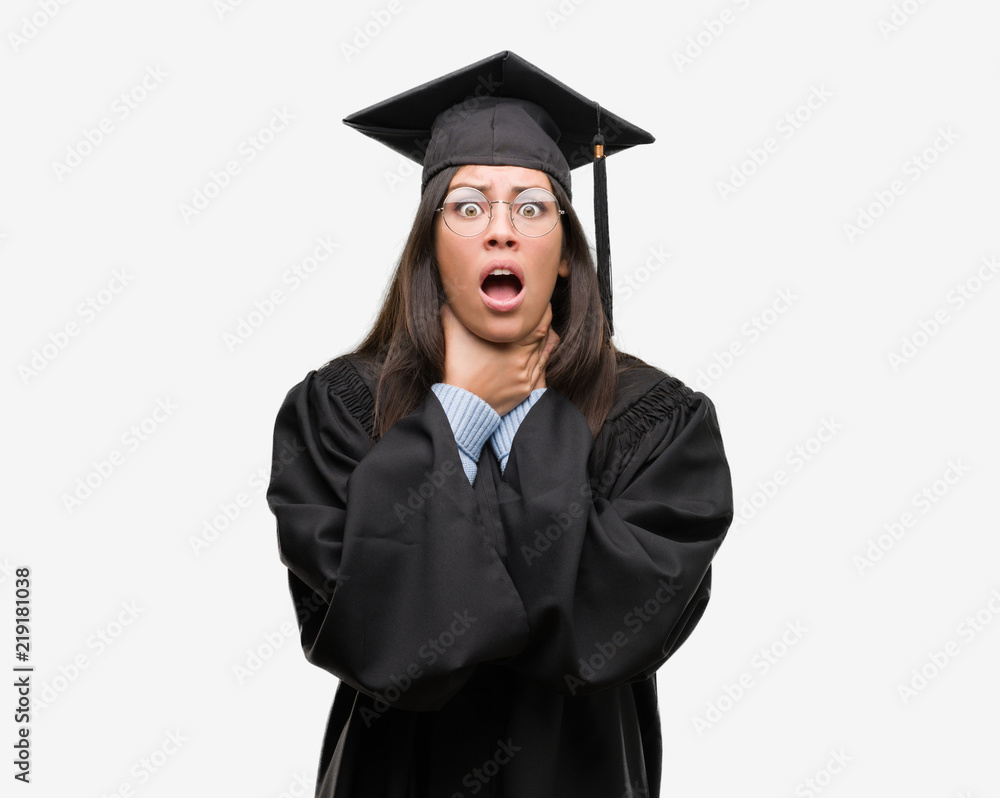 Young hispanic woman wearing graduated cap and uniform shouting and suffocate because painful strangle. Health problem. Asphyxiate and suicide concept. Young hispanic woman wearing graduated cap and uniform shouting and suffocate because painful strangle. Health problem. Asphyxiate and suicide concept.