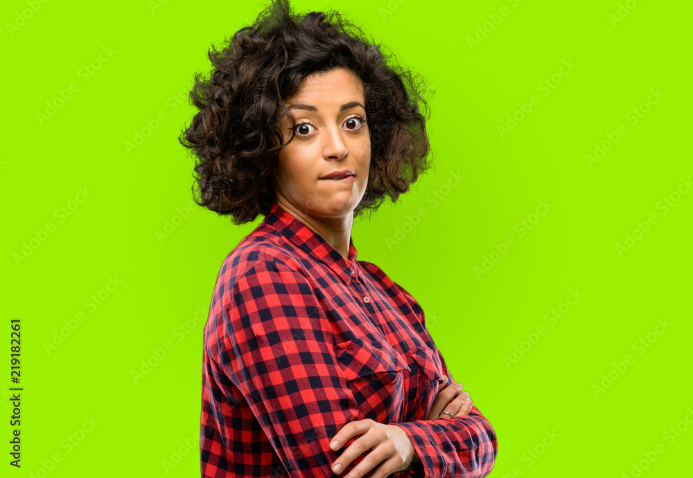 Beautiful arab woman nervous and scared biting lips looking camera with impatient expression, pensive Beautiful arab woman nervous and scared biting lips looking camera with impatient expression, pensive