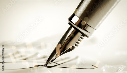 Signing a signature with a fountain pen photo