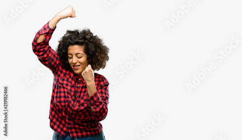 Beautiful arab woman happy and excited expressing winning gesture. Successful and celebrating victory, triumphant