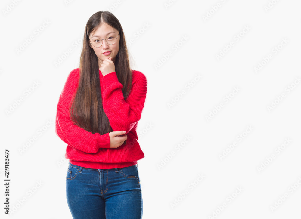 Young Chinese woman over isolated background wearing glasses looking confident at the camera with smile with crossed arms and hand raised on chin. Thinking positive. Young Chinese woman over isolated background wearing glasses looking confident at the camera with smile with crossed arms and hand raised on chin. Thinking positive.