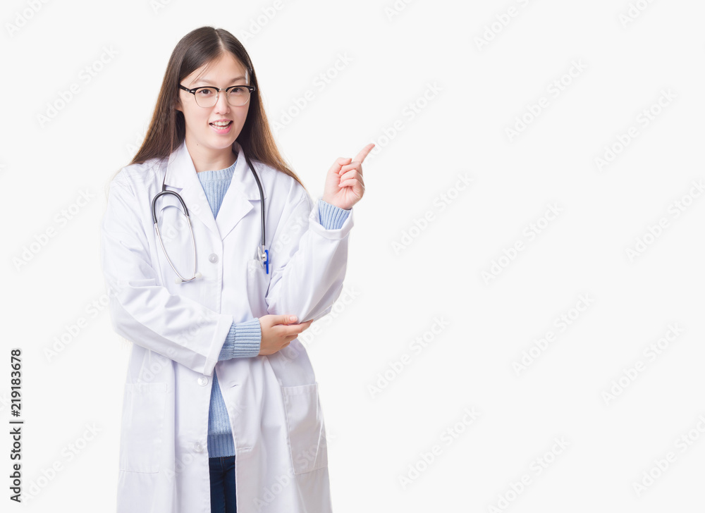 Young Chinese doctor woman over isolated background with a big smile on face, pointing with hand and finger to the side looking at the camera. Young Chinese doctor woman over isolated background with a big smile on face, pointing with hand and finger to the side looking at the camera.
