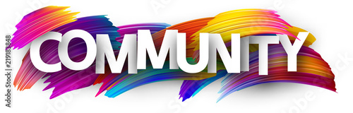 Community sign with colorful brush strokes.