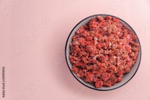 Natural raw ingredients for pet food on pink background. Flat lay. photo