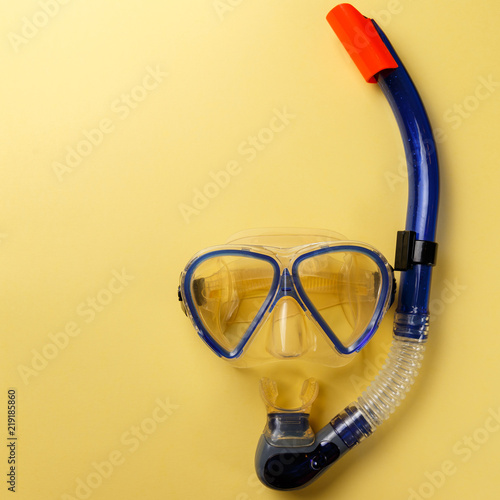 Diving equipment. Snorkeling mask and tube on yellow background. Colorful background. Top view. Copy space. Flat lay