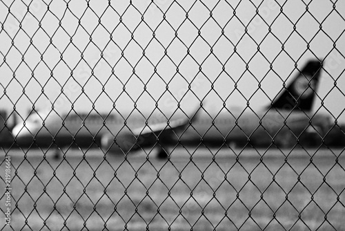 Ruzyne  Czech republic - August 16  2018  iron fence with Lufthansa aeroplane on background in Vaclav Havel airport in Prague during summer holiday evening