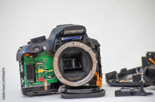 Disassembly and repair of professional dslr camera. Specialist of the center of the center for repair of lenses for a camera with instruments. 