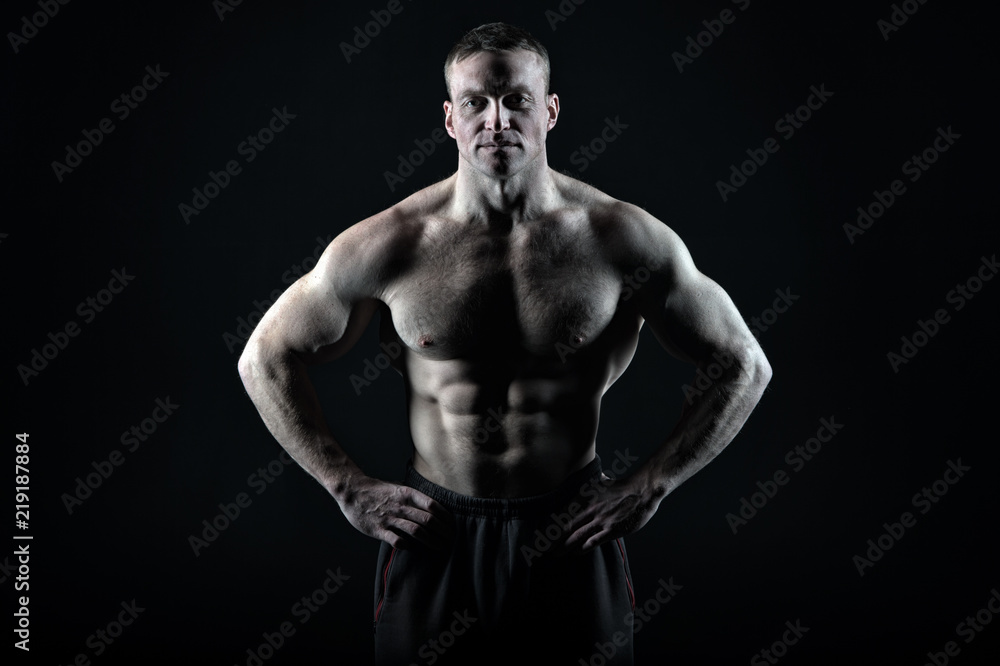 Great body result of regular training gym. Man muscular torso body posing confidently black background, copy space. Bodybuilder achievement great shape. Bodybuilder tense muscles looks attractive