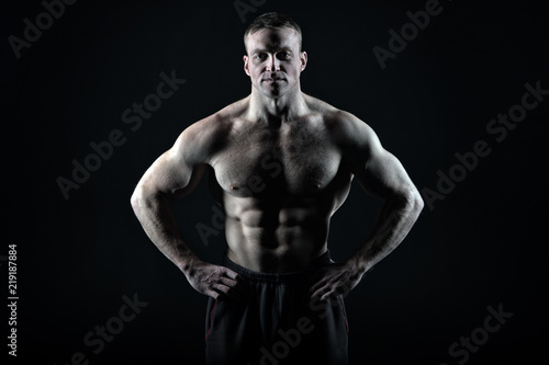 Great body result of regular training gym. Man muscular torso body posing confidently black background, copy space. Bodybuilder achievement great shape. Bodybuilder tense muscles looks attractive © be free